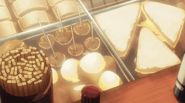 a display of food with a glass of red liquid on the table