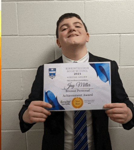 a young man in a suit and tie is holding a certificate for jay miller