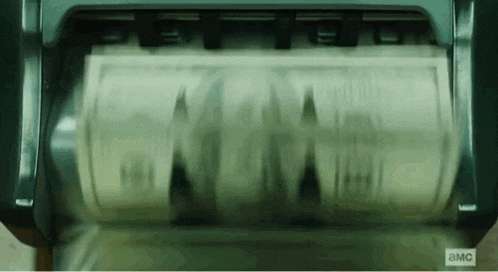 a roll of money is being counted in a machine that says ' a.m.c ' on the bottom .
