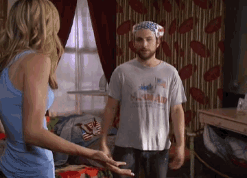 a man wearing a hawaii t-shirt is standing next to a woman