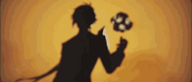 a silhouette of a man holding a flower in his hand