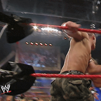 a man in a wrestling ring with a w logo on the side