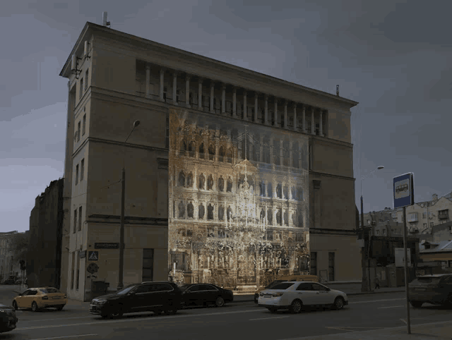 a large building with a picture of a building projected on it