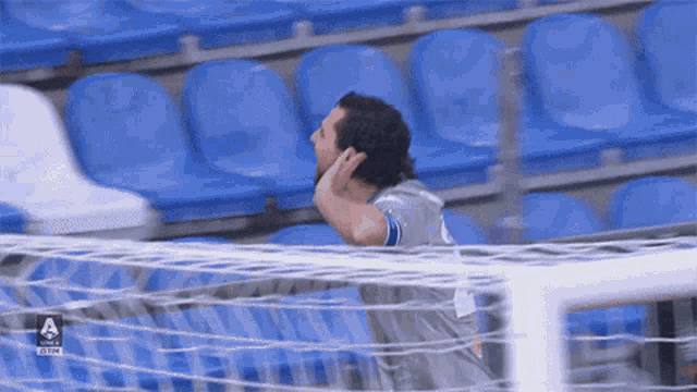 a soccer player in a stadium with a tim logo on the bottom right