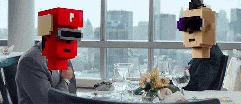 a man in a suit sits at a table with a red box on his head that says p