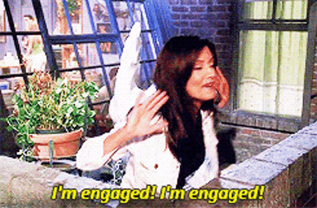a woman on a balcony says i 'm engaged i 'm engaged !