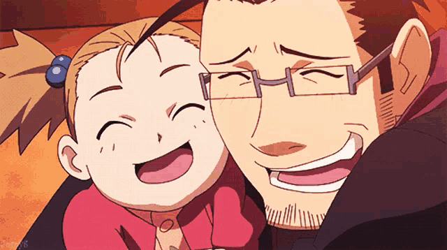 a man with glasses is holding a little girl who is smiling for the camera