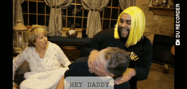 a man in a yellow wig says hey daddy to another man