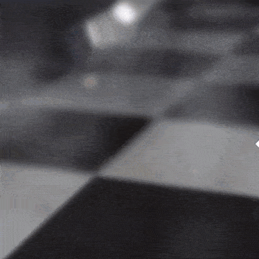 a black and white checkered floor with a white arrow pointing to the left