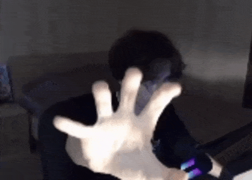 a person is sitting in a chair with their hands outstretched .
