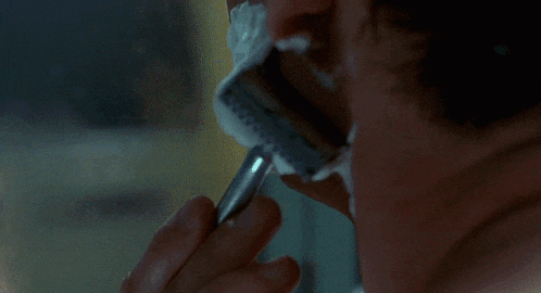 a man is shaving his face with a razor that says safety razor