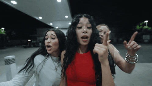 a woman in a red top is surrounded by other women