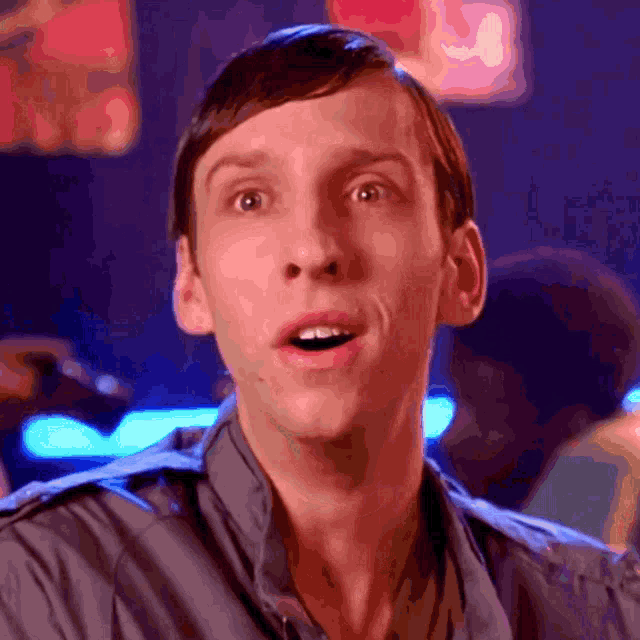a close up of a man 's face with a surprised look