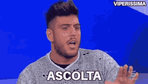 a man with a beard is wearing a sweater that says ascolta on it