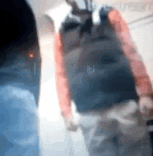 a blurry image of a person walking with a backpack