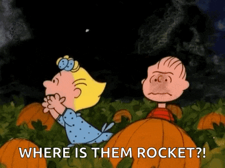 a cartoon of a boy and a girl standing in a pumpkin patch looking at a rocket .