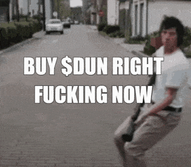 a man walking down a street with the words buy $ dun right fucking now on the bottom