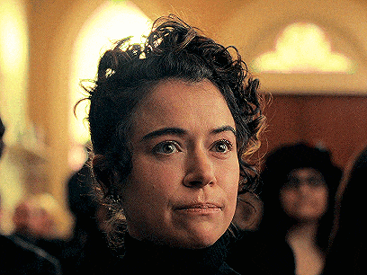 a close up of a woman 's face with a serious look on her face