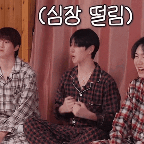 three young men in plaid pajamas are sitting in front of a pink curtain