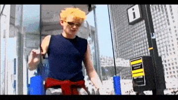 a man with yellow hair is standing in front of a sign that says i