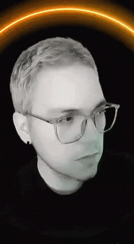 a black and white photo of a man wearing glasses and earrings .