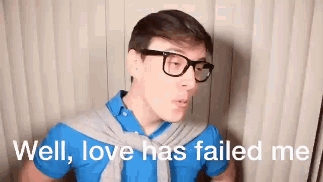 a man wearing glasses and a blue shirt is talking about love .