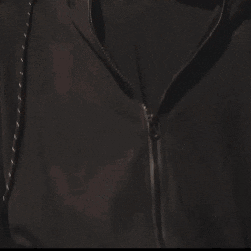 a close up of a young man 's face with a black shirt on
