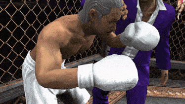 a man wearing white boxing gloves is standing next to another man in purple