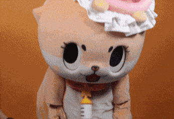 a stuffed animal with a bottle attached to it 's neck