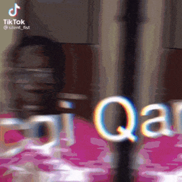 a blurred image of a person with the word qaar on it
