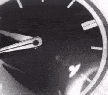 a black and white photo of a clock with roman numerals and a white border