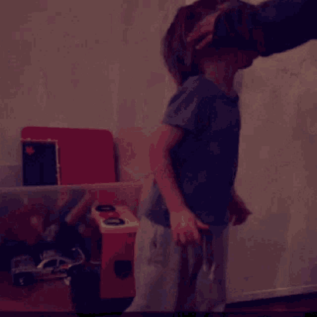 a young boy wearing sunglasses is playing with a toy