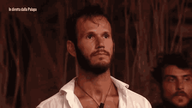 a man with a beard looks at the camera with the words in diretta dalla palapa below him