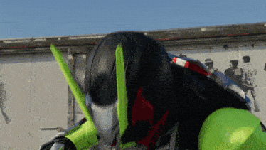 a person in a black and green costume with a green helmet