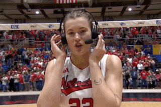 a female basketball player wearing headphones and a jersey with the number 22 on it