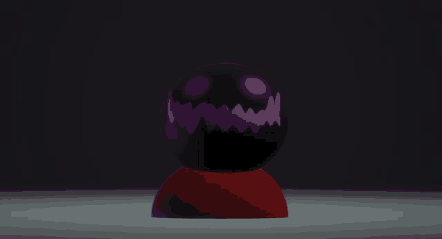 a black sphere with purple eyes and teeth on a red base