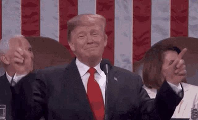 donald trump is giving a thumbs up while giving a speech at the united states capitol .