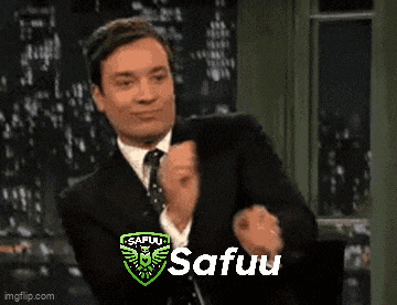 a man in a suit and tie is clapping his hands in front of a sign that says safuu on it .