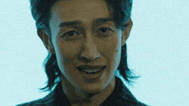 a close up of a man 's face with a smile on his face