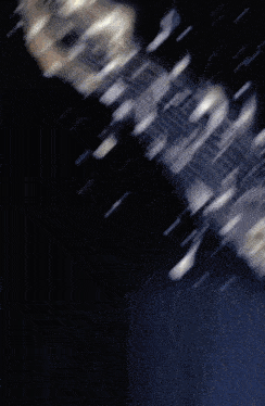 a dark background with a few sparkles in it