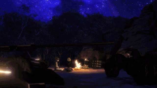 a fire is lit up in the middle of a dark forest