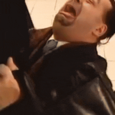 two men are fighting in a grocery store and one man is holding another man 's head