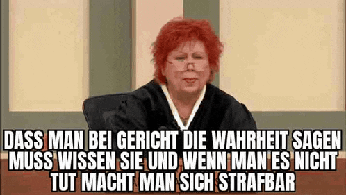 a woman in a judge 's robe is sitting in a courtroom with a caption in german .