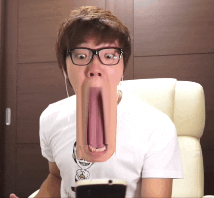 a man wearing glasses and a white shirt has a very long tongue