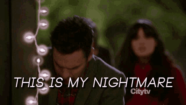 a man in a suit says " this is my nightmare " in front of a string of lights