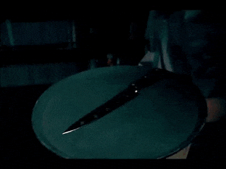 a knife is laying on a green plate