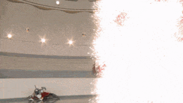 a robot is laying on the ground with a huge explosion coming out of it