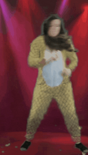 a woman in yellow pajamas is dancing with a pillow in her hand