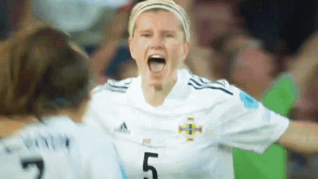 a soccer player with the number 5 on her jersey is screaming