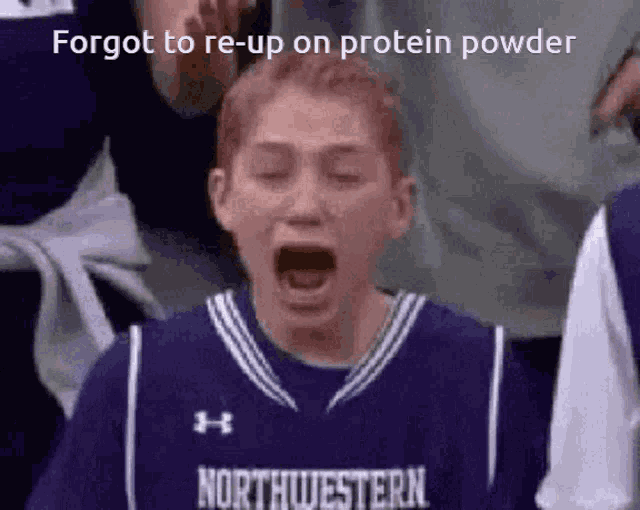a boy in a northwestern jersey is yawning
